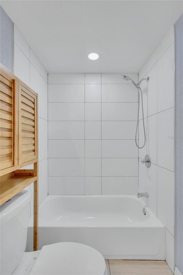 full bathroom featuring washtub / shower combination and toilet