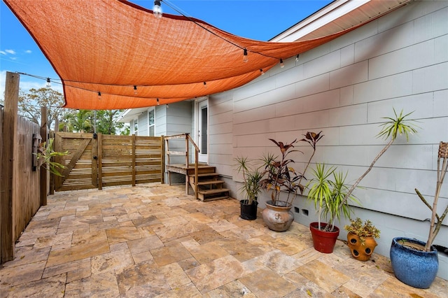 view of patio with fence and a gate