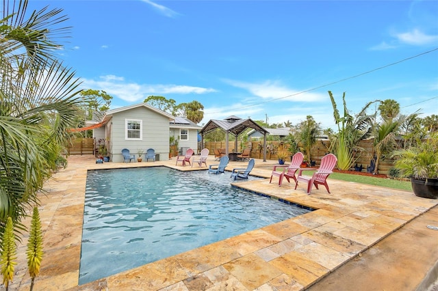 view of swimming pool with a gazebo, a patio, fence, and a fenced in pool