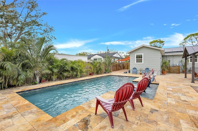 view of swimming pool with a patio area, a fenced backyard, and a fenced in pool