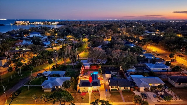 aerial view at dusk with a water view