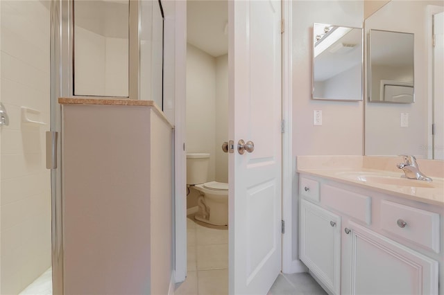 bathroom with vanity, tile patterned flooring, a shower stall, and toilet