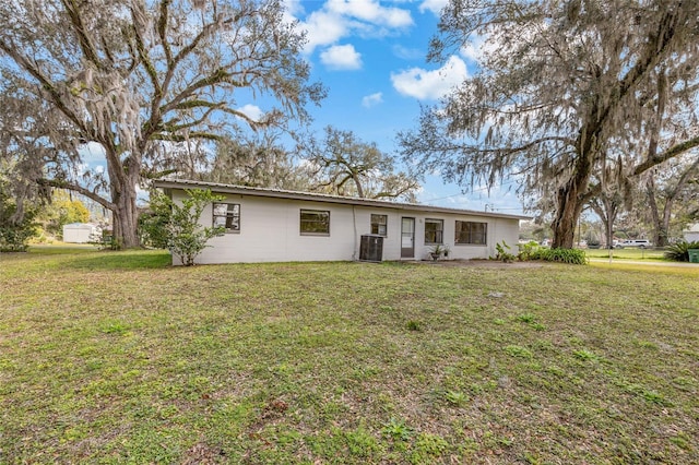 single story home with a front lawn and central air condition unit