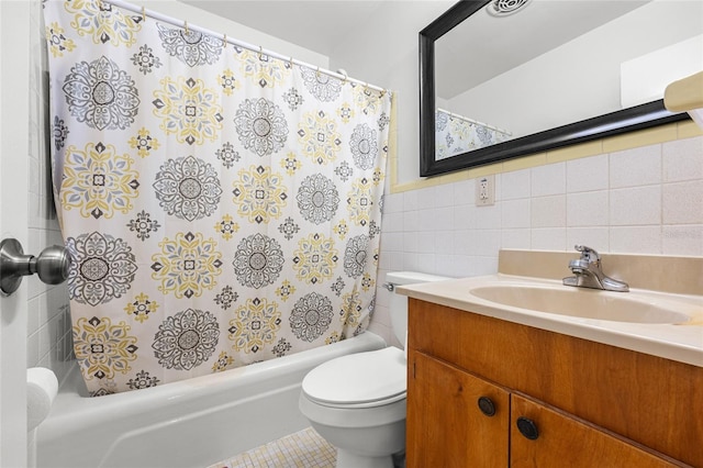 bathroom with toilet, vanity, tile walls, wainscoting, and shower / bathtub combination with curtain