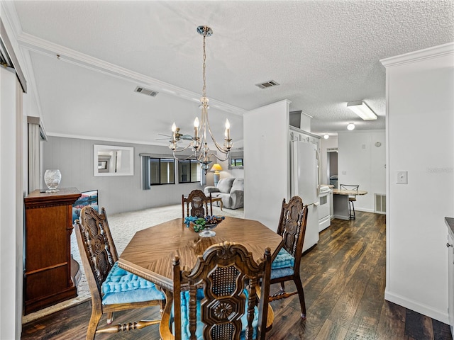 dining space with a textured ceiling, dark wood-type flooring, and visible vents