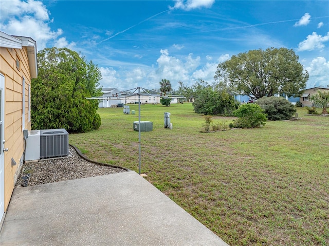 view of yard featuring a patio area and central air condition unit