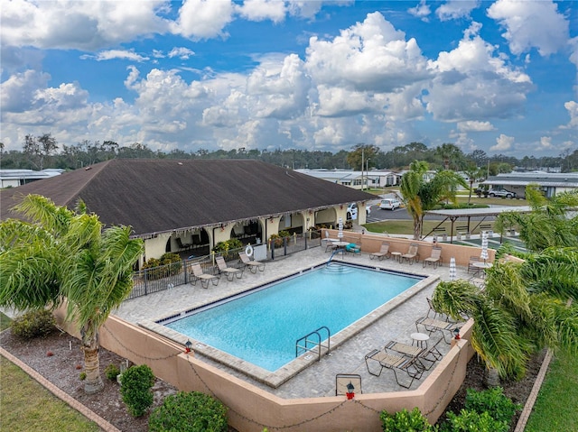 pool featuring a patio and fence