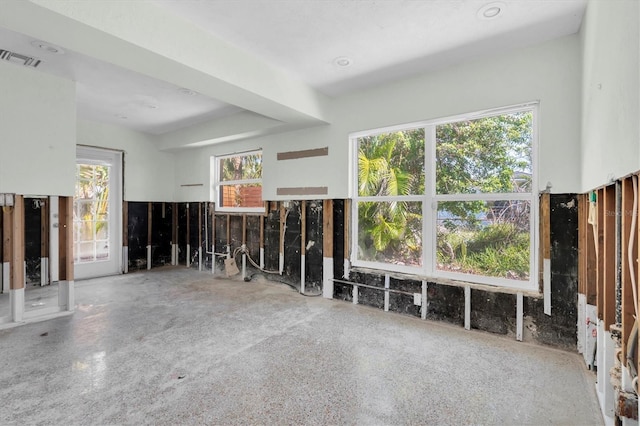 unfurnished living room with visible vents