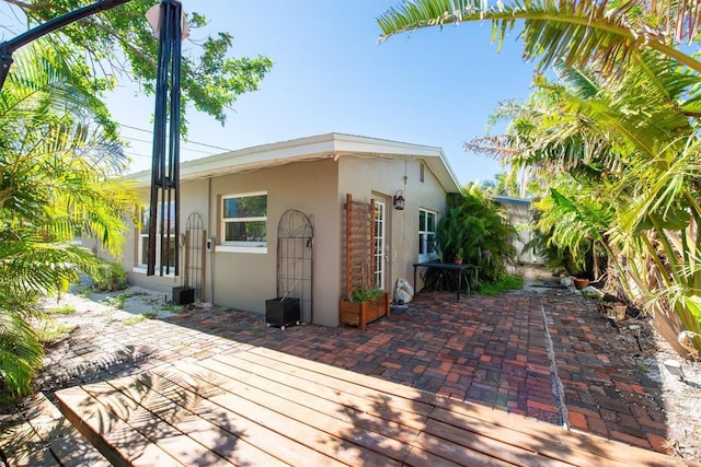 view of home's exterior with a patio and stucco siding