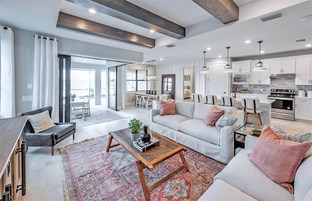 living area with recessed lighting, visible vents, beam ceiling, and light tile patterned flooring