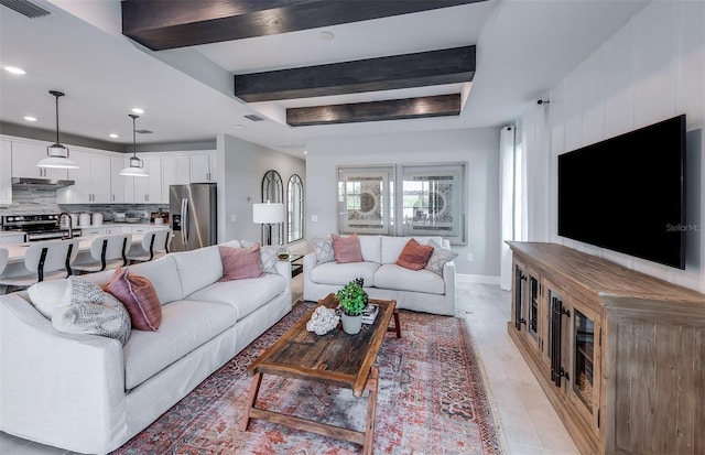 living area featuring baseboards, visible vents, a raised ceiling, beam ceiling, and recessed lighting