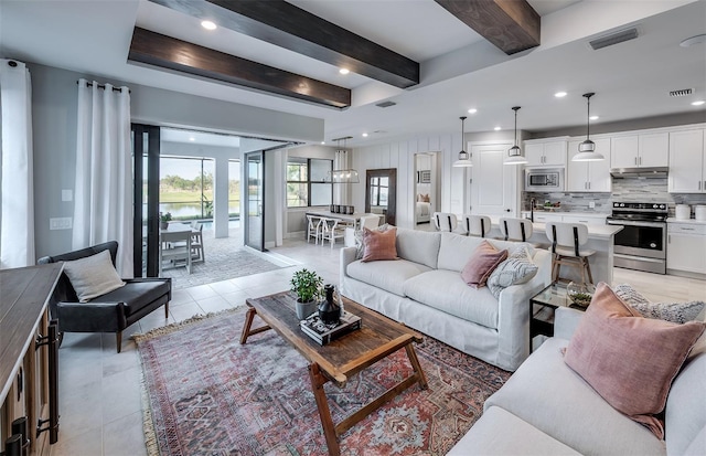 living area with light tile patterned floors, visible vents, beamed ceiling, and recessed lighting