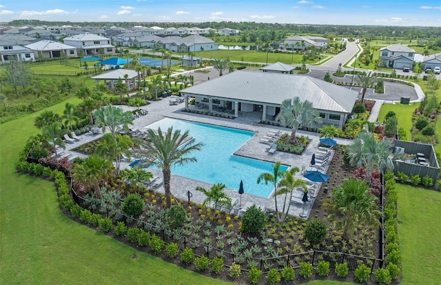 community pool with a patio area, a residential view, and fence