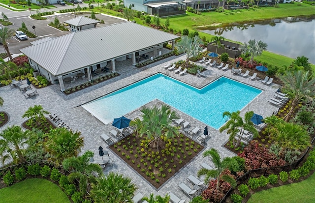 community pool with a water view and a patio