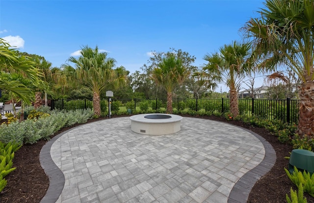 view of home's community with a fire pit, a patio, and fence