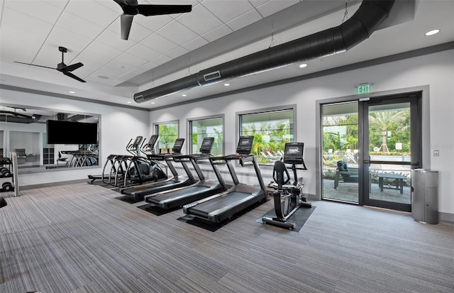 exercise room featuring ceiling fan, recessed lighting, carpet floors, visible vents, and a raised ceiling