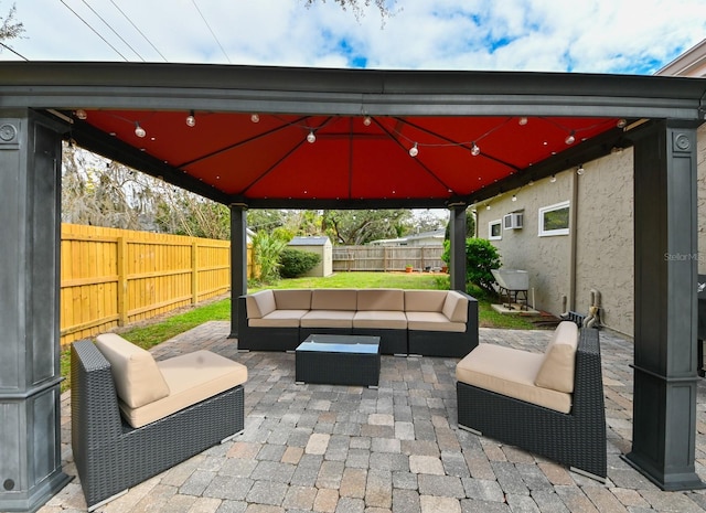 view of patio / terrace featuring a fenced backyard, an outdoor hangout area, and a gazebo