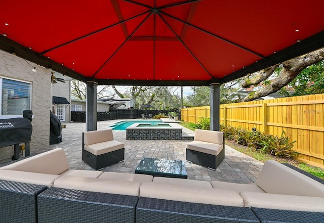 view of patio featuring outdoor lounge area, a fenced backyard, and a fenced in pool