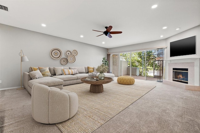 living area featuring carpet flooring, a tile fireplace, and recessed lighting