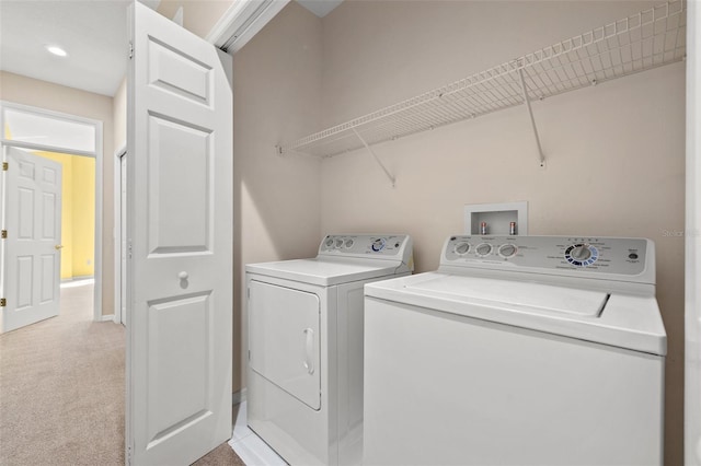 washroom with laundry area, light colored carpet, and washing machine and clothes dryer