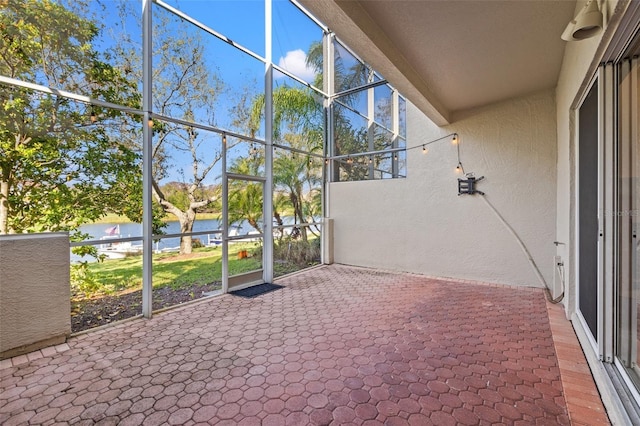 unfurnished sunroom with a water view