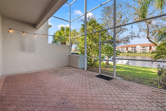 unfurnished sunroom with a water view