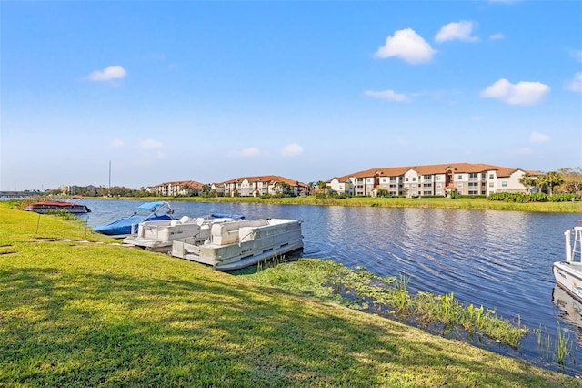 dock area featuring a water view and a yard