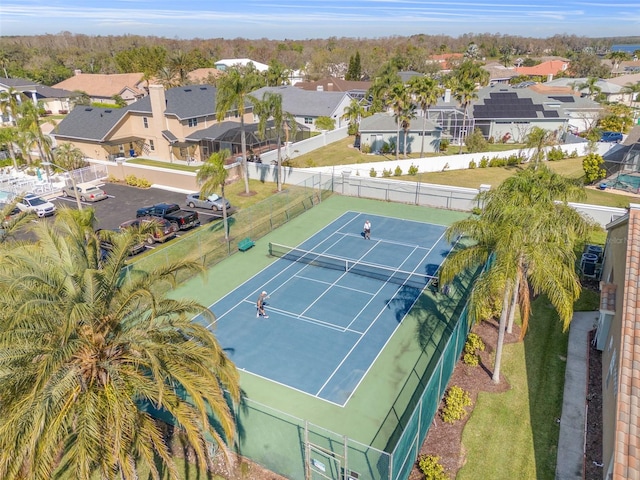 view of sport court with fence and a residential view