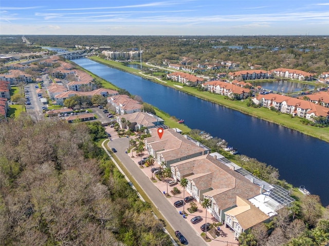 birds eye view of property with a water view and a residential view