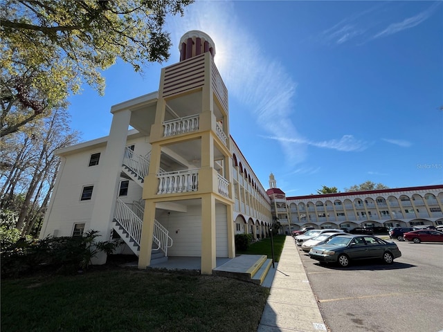 view of building exterior featuring uncovered parking