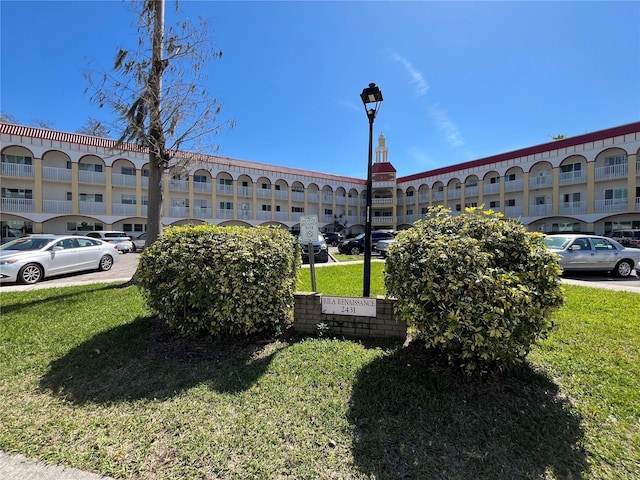 view of building exterior with uncovered parking