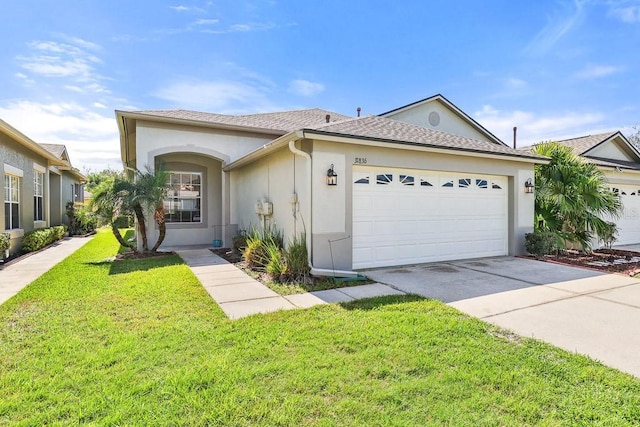 ranch-style house featuring a garage, concrete driveway, stucco siding, roof with shingles, and a front yard