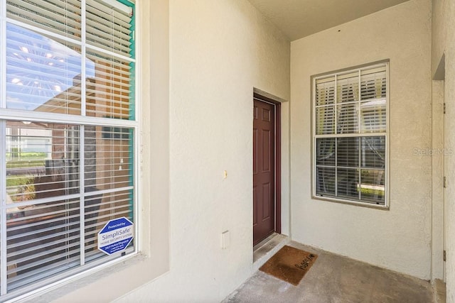 doorway to property featuring stucco siding