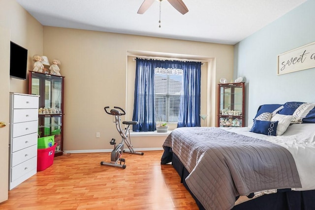 bedroom featuring light wood-style floors, ceiling fan, and baseboards