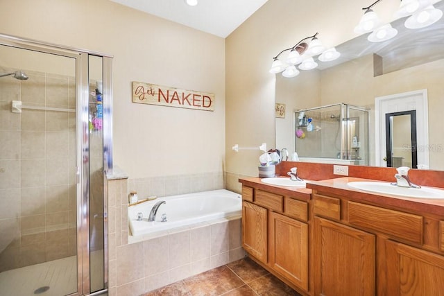 bathroom featuring tile patterned flooring, a garden tub, a sink, and a shower stall