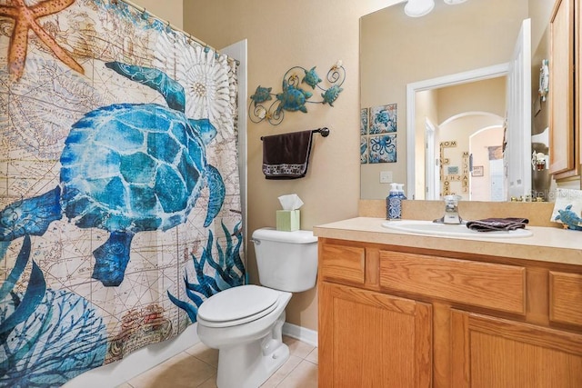 bathroom featuring tile patterned flooring, a shower with curtain, vanity, and toilet