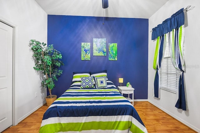 bedroom featuring ceiling fan, wood finished floors, and baseboards