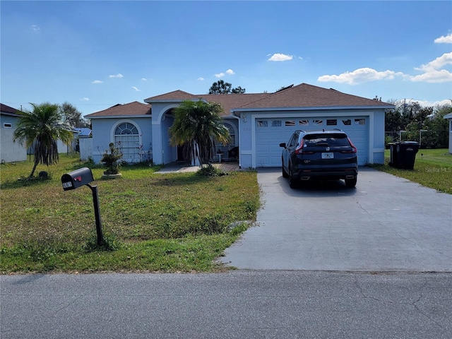 view of front of house with driveway, an attached garage, a front yard, and stucco siding