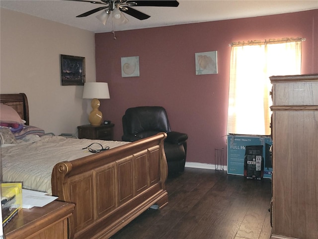 bedroom with dark wood-style floors, ceiling fan, and baseboards