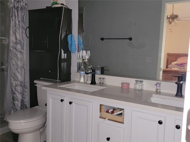 full bathroom with double vanity, a shower with shower curtain, a sink, and toilet