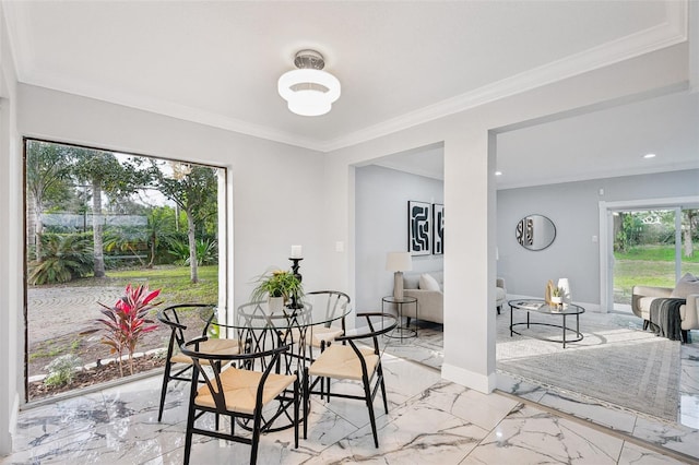 dining room with marble finish floor, baseboards, and ornamental molding