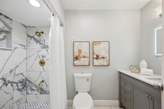 bathroom with curtained shower, marble finish floor, vanity, and baseboards