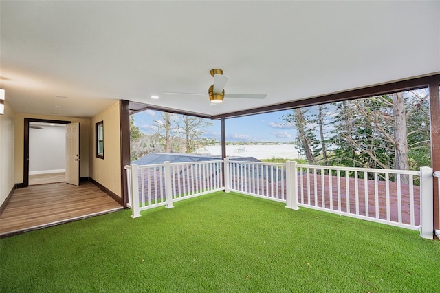 view of yard with ceiling fan and fence