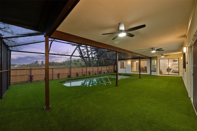 view of yard with ceiling fan, a fenced backyard, a lanai, a fenced in pool, and a patio area