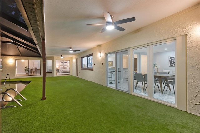 view of yard featuring ceiling fan