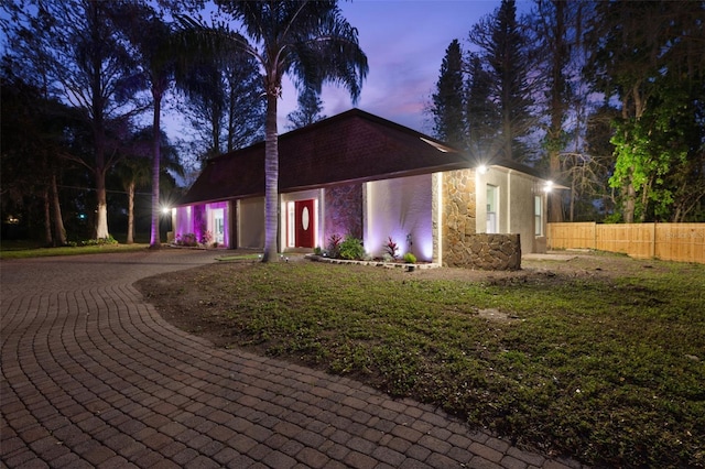 view of front of home featuring fence and stucco siding