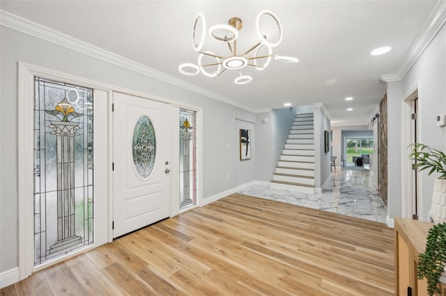 foyer with a notable chandelier, baseboards, stairway, light wood-type flooring, and crown molding