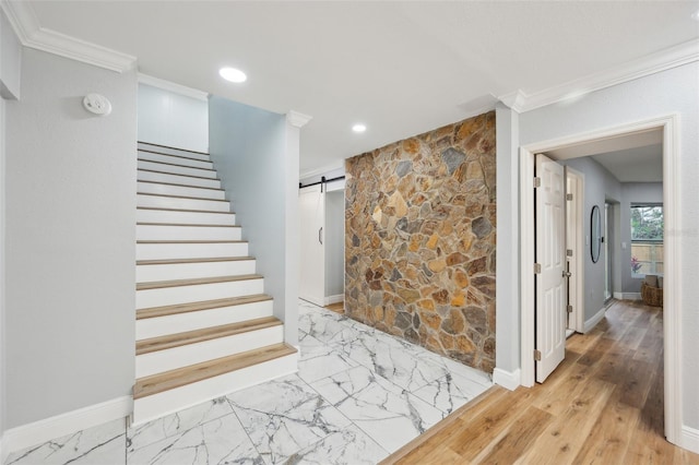 stairs featuring marble finish floor, recessed lighting, a barn door, ornamental molding, and baseboards