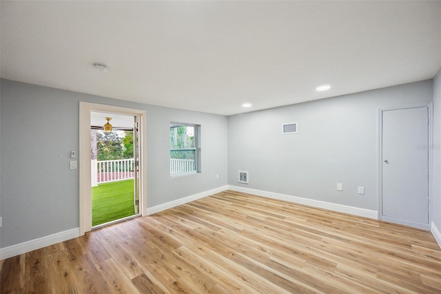 unfurnished room with light wood-style flooring, visible vents, baseboards, and recessed lighting