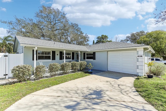 ranch-style house with stucco siding, a shingled roof, an attached garage, fence, and driveway